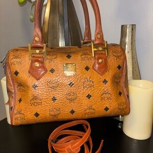 MCM Cognac Leather Visetus Satchel with Black Accents and Crossbody Strap.